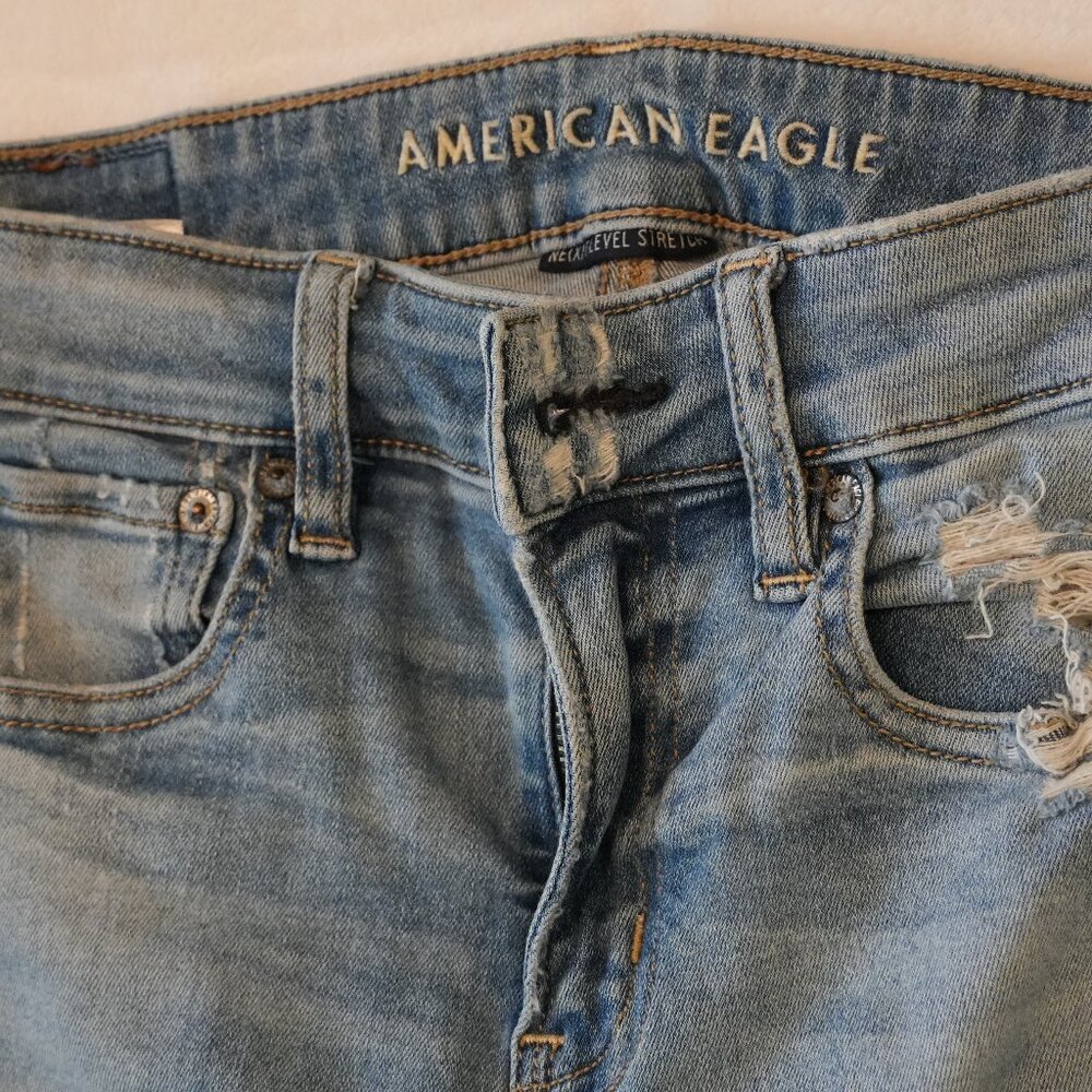 American Eagle: Next Level Stretch Distressed Hi-Rise Jegging in Light Blue - Si